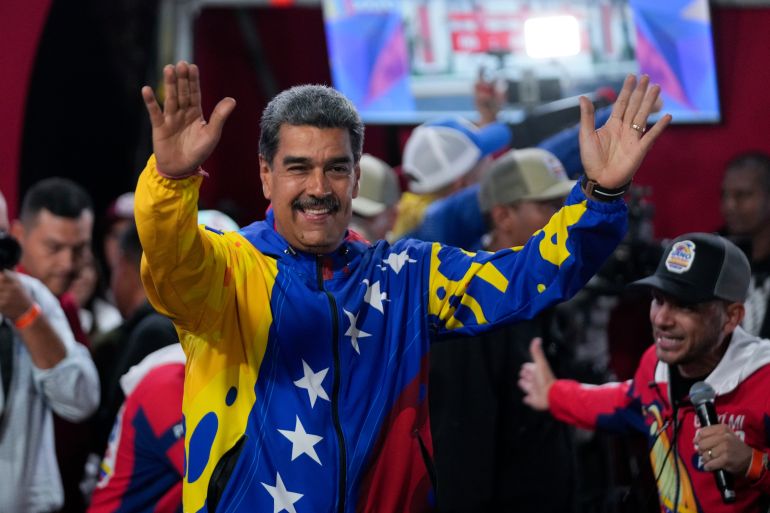 President Nicolas Maduro addresses supporters gathered outside the Miraflores presidential palace after electoral authorities declared him the winner of the presidential election in Caracas, Venezuela, Monday,