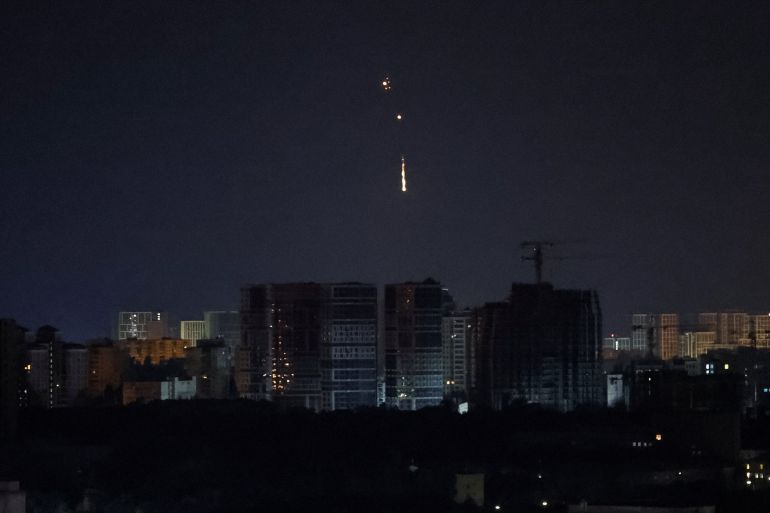 A drone exploding in the night sky above Kyiv.