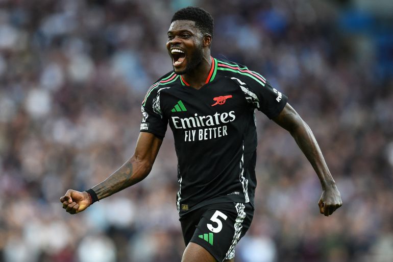 Soccer Football - Premier League - Aston Villa v Arsenal - Villa Park, Birmingham, Britain - August 24, 2024 Arsenal's Thomas Partey celebrates scoring their second goal REUTERS/Peter Powell EDITORIAL USE ONLY. NO USE WITH UNAUTHORIZED AUDIO, VIDEO, DATA, FIXTURE LISTS, CLUB/LEAGUE LOGOS OR 'LIVE' SERVICES. ONLINE IN-MATCH USE LIMITED TO 120 IMAGES, NO VIDEO EMULATION. NO USE IN BETTING, GAMES OR SINGLE CLUB/LEAGUE/PLAYER PUBLICATIONS. PLEASE CONTACT YOUR ACCOUNT REPRESENTATIVE FOR FURTHER DETAILS..