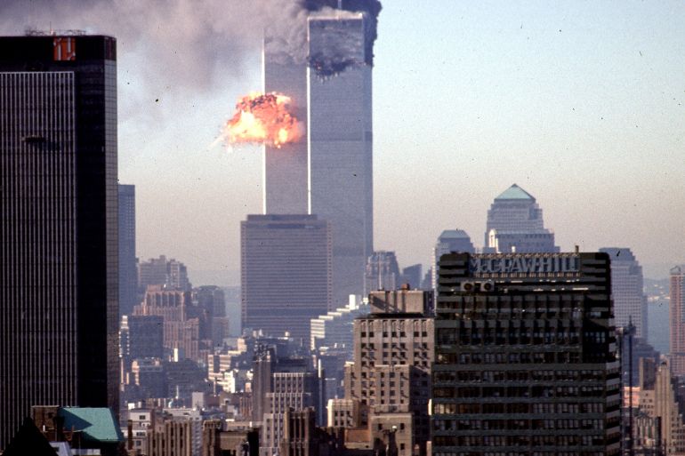 Smoke and flames billow from one of the World Trade Center's two towers after it was struck by a hijacked commercial aircraft.