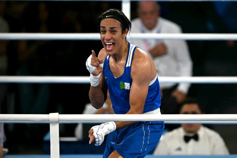 Algeria's Imane Khelif (Blue) reacts after beating Thailand's Janjaem Suwannapheng in the women's 66kg semi-final boxing match during the Paris 2024 Olympic Games at the Roland-Garros Stadium, in Paris on August 6, 2024. (Photo by Mauro PIMENTEL / AFP)