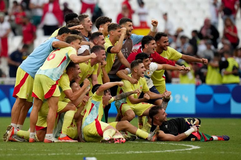 Spain players celebrate after wining against Morocco during a men's semifinal soccer match at the 2024 Summer Olympics, Monday, Aug. 5, 2024, at Marseille Stadium in Marseille, France. (AP Photo/Daniel Cole)