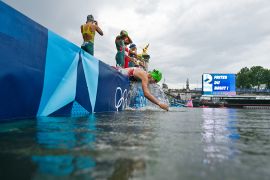 Athletes get ready to compete in the swimming race in the River Seine during the women&#039;s individual triathlon at the Paris 2024 Olympic Games [Martin Bureau - Pool/Getty Images]