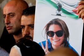 A person holds an image of Turkish-American activist Aysenur Ezgi Eygi, who was shot dead by Israeli forces, as Palestinians march to honour her, in Nablus, the Israeli-occupied West Bank, on September 8, 2024 [Raneen Sawafta/Reuters]