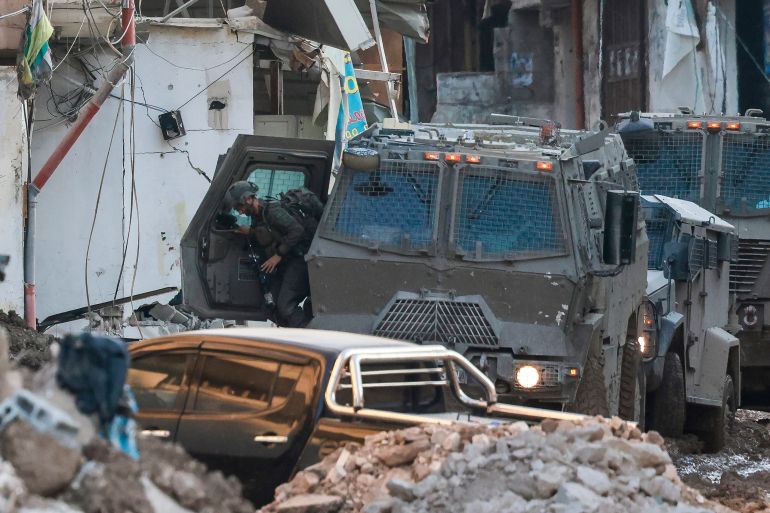 Israeli army soldiers keep position during a raid in Tulkarem camp on September 10, 2024, amid a large-scale military offensive launched a week earlier in the occupied West Bank.