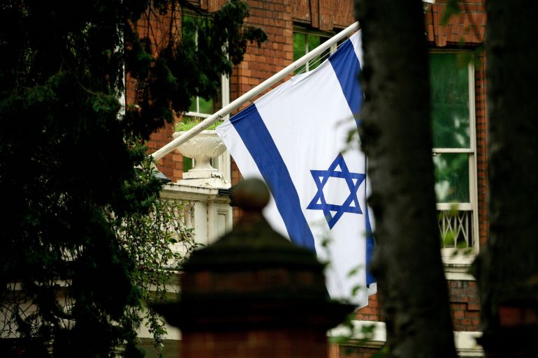 The Israeli flag flies at the main entrance to the Israeli Embassy in London October 5, 2006. London police defended on Thursday a controversial decision to excuse a Muslim firearms officer from guard duty at the Israeli embassy saying it was based on a potential safety risk and not on the man's personal views. REUTERS/Dylan Martinez (BRITAIN)