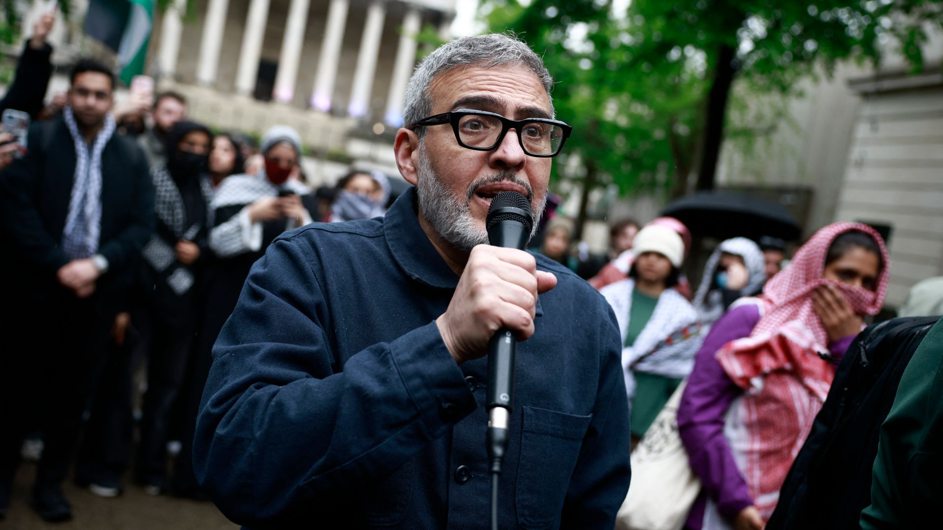 British-Palestinian plastic surgeon specialising in conflict injuries Ghassan Abu Sitta speaks to the press during a demonstration in support to Palestinian people at University College London (UCL) main entrance, on May 3, 2024, in London, as a pro-Palestinian camp has been set up on the campus. - In an echo of tense demonstrations rocking many top US universities, students at UCL London and in several cities in the UK have staged a number of protests over the Israel-Hamas war and ensuing humanitarian crisis in the besieged Palestinian territory of Gaza. (Photo by BENJAMIN CREMEL / AFP)