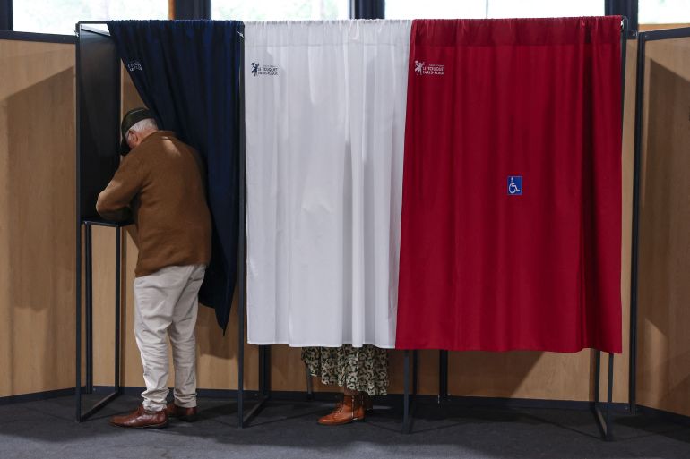 Voters at a polling station during the second round of French parliamentary elections in Le Touquet-Paris-Plage, northern France, 07 July 2024. MOHAMMED BADRA/Pool via REUTERS