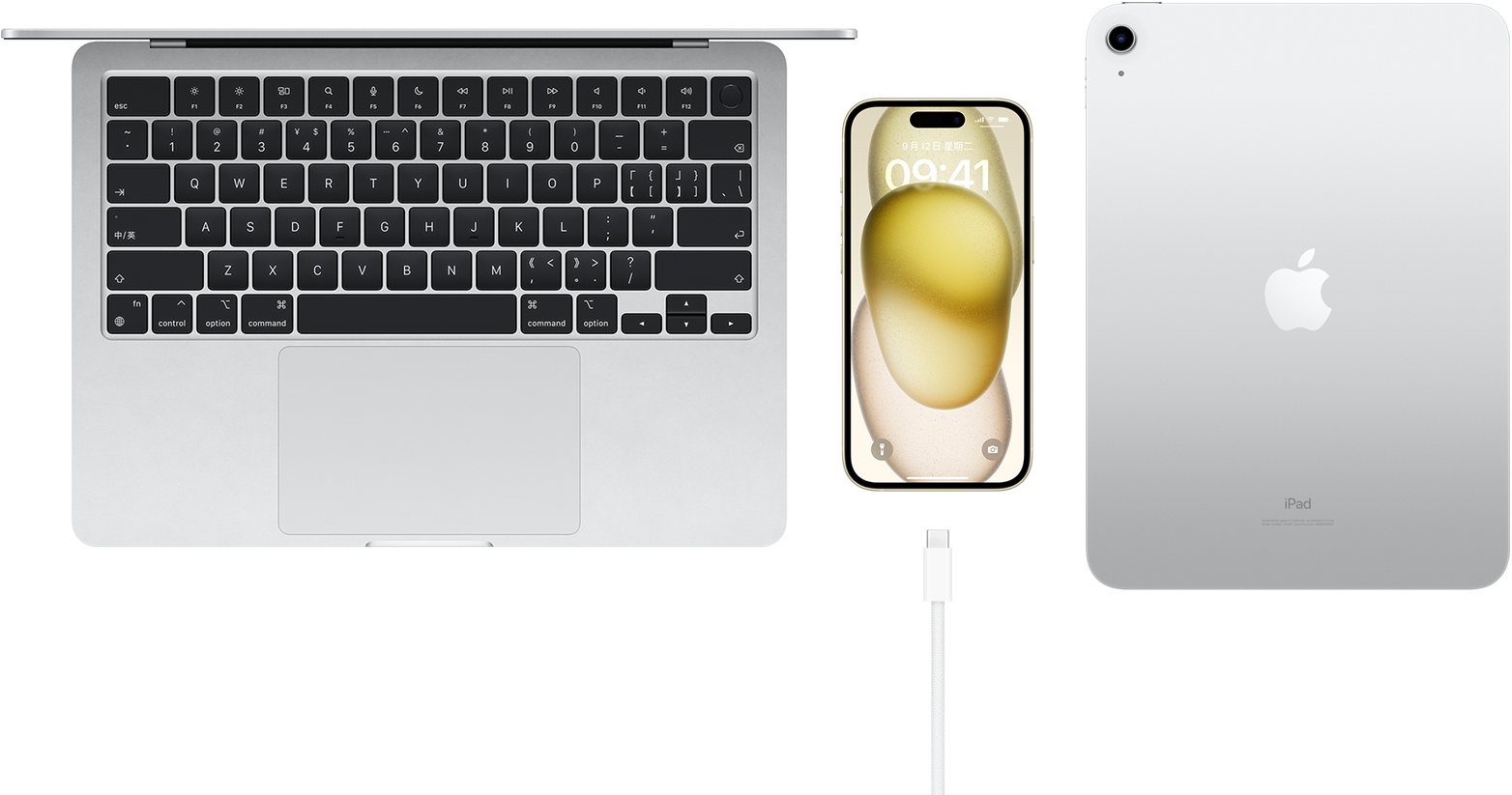 MacBook Pro、配备 USB-C 接口的 iPhone 15 以及 iPad 的俯视图