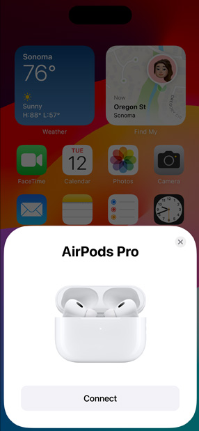 Casing Pengisian Daya MagSafe memperlihatkan AirPods Pro di samping iPhone. Petak kecil di layar home iPhone menampilkan pop-up dengan tombol hubungkan yang dengan mudah memasangkan AirPods saat diketuk.