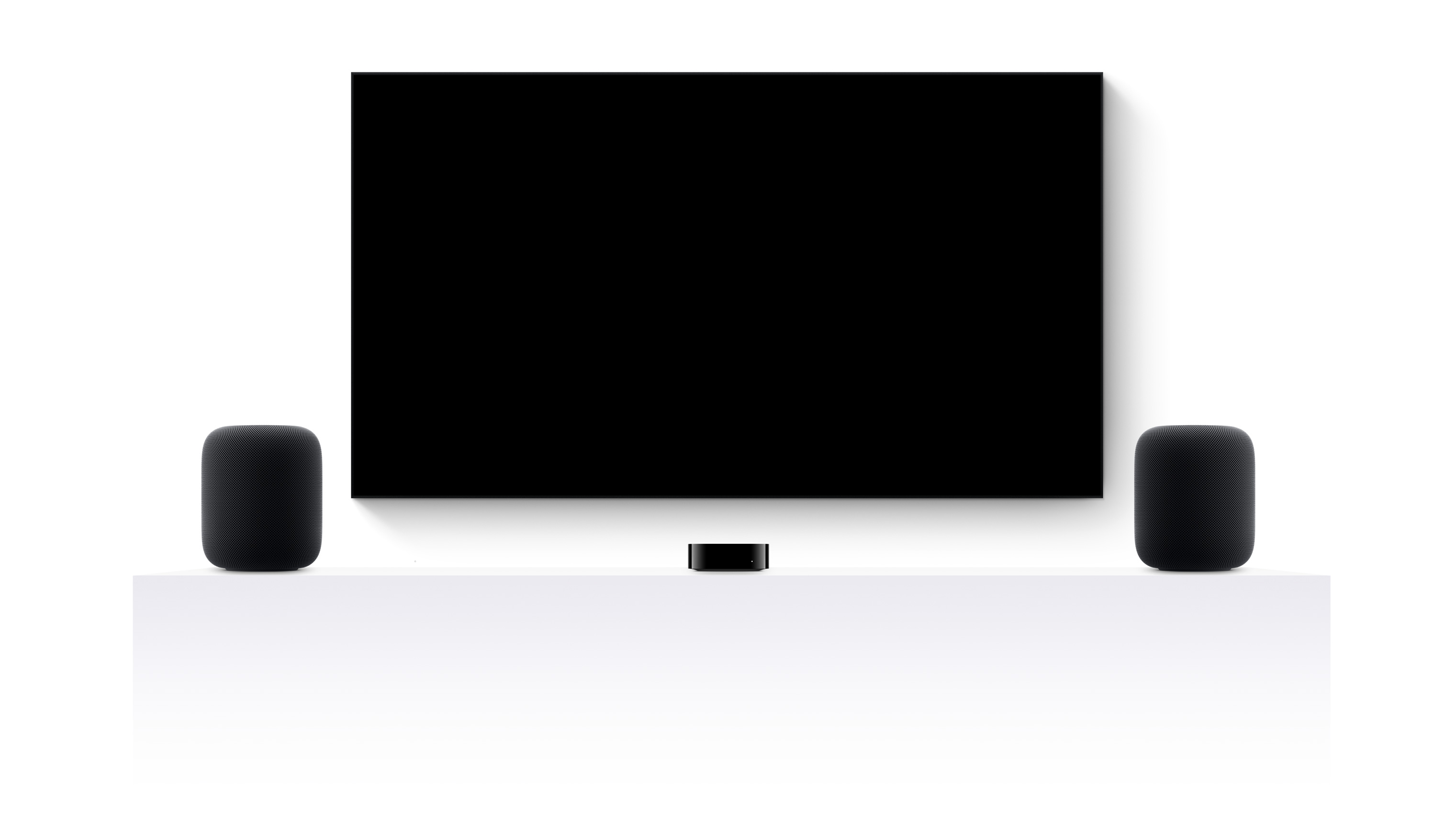 Apple TV 4K, two HomePods and a flat-screen television showing an edited trailer of various Apple TV+ movies and shows