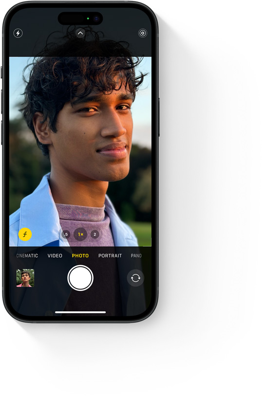 Close-up portrait photo of a young man outside