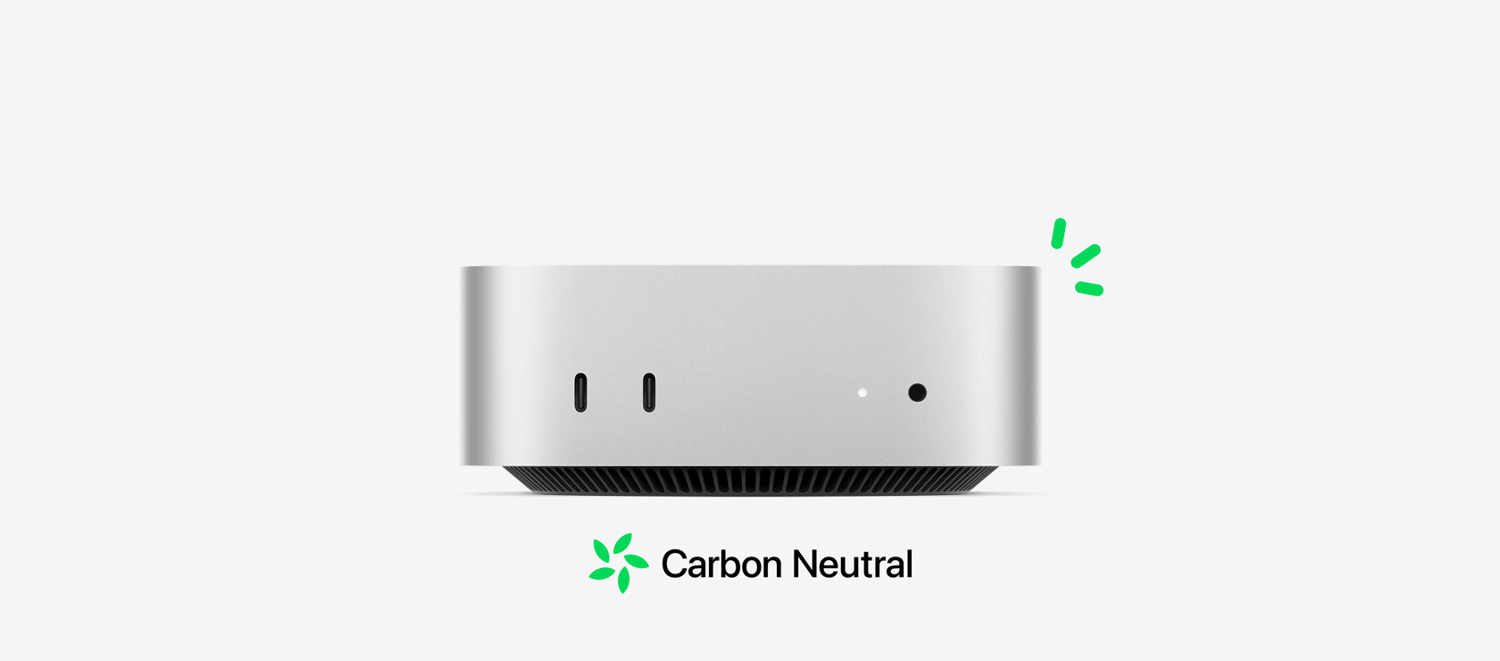 Vooraanzicht van een zilverkleurige Mac mini met de poorten aan de voorkant. De tekst over CO₂-neutraliteit wordt geïllustreerd met kleine groene accenten.