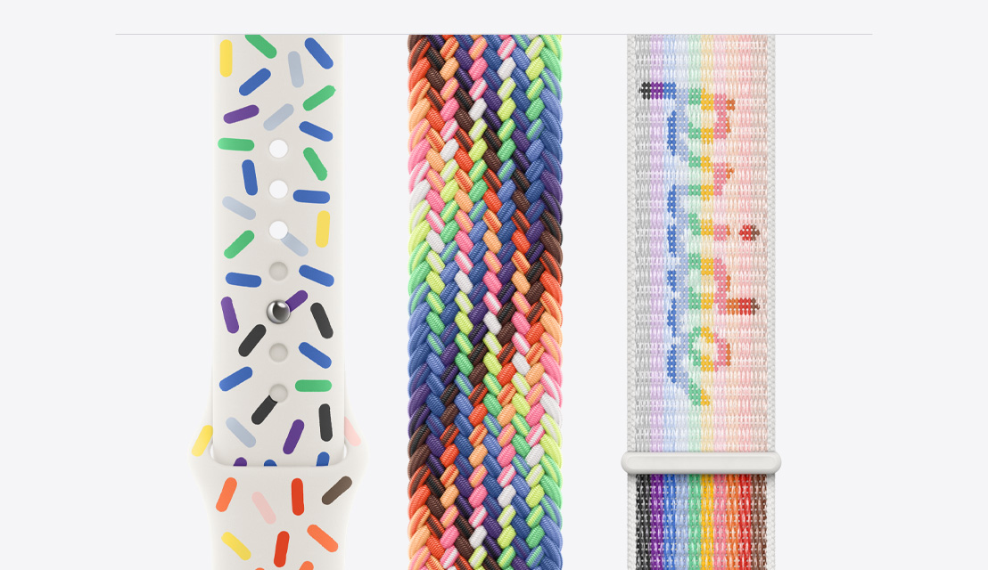 Three Apple Watch bands laying flat, the Pride Edition Sport Band on the left, the new Pride Edition Braided Solo Loop in the middle and the Pride Edition Sport Loop on the right.