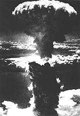 A nuclear mushroom cloud rises above the city of Nagasaki