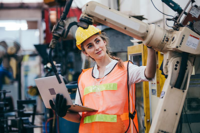 Woman working in a factory with a machine