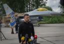 Ukraine’s President Volodymyr Zelensky against the background of F-16 fighter jets (Efrem Lukatsky/AP)