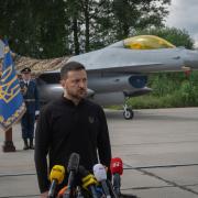 Ukraine’s President Volodymyr Zelensky against the background of F-16 fighter jets (Efrem Lukatsky/AP)