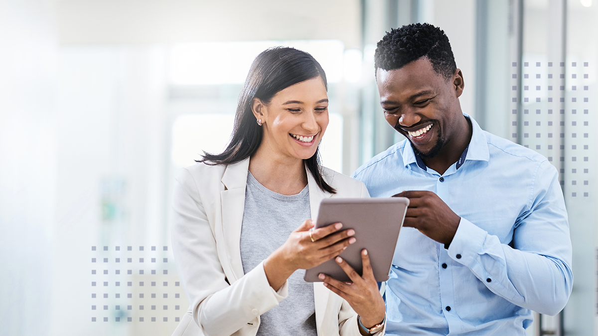 two businesspeople discussing something on a digital tablet