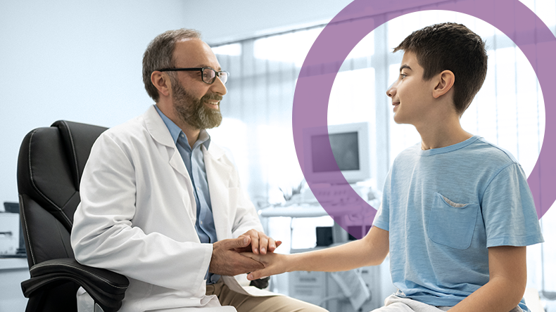 Healthcare professional holds a child's hand.