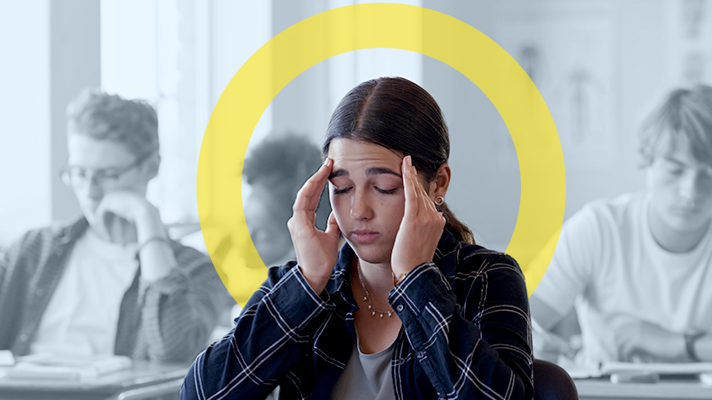 Young women with hands on the sides of her head looking like she is in pain