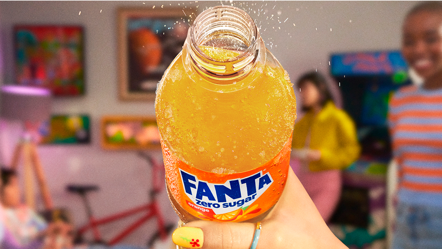 woman drinking a bottle of fanta zero sugar