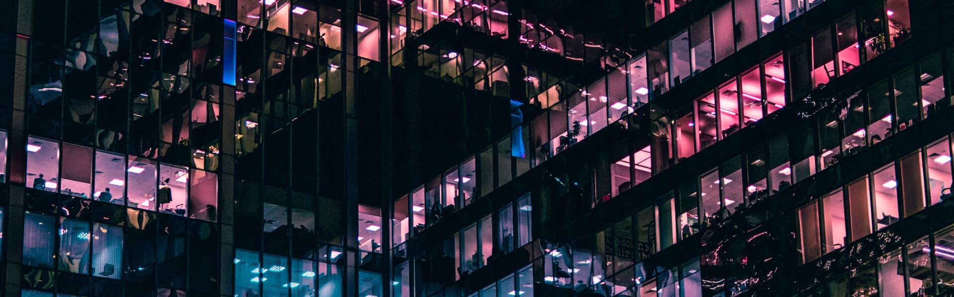 Office building at night with lights from windows.