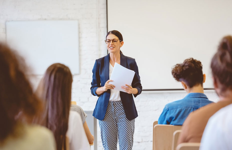 Teacher standing at the front of a classroom