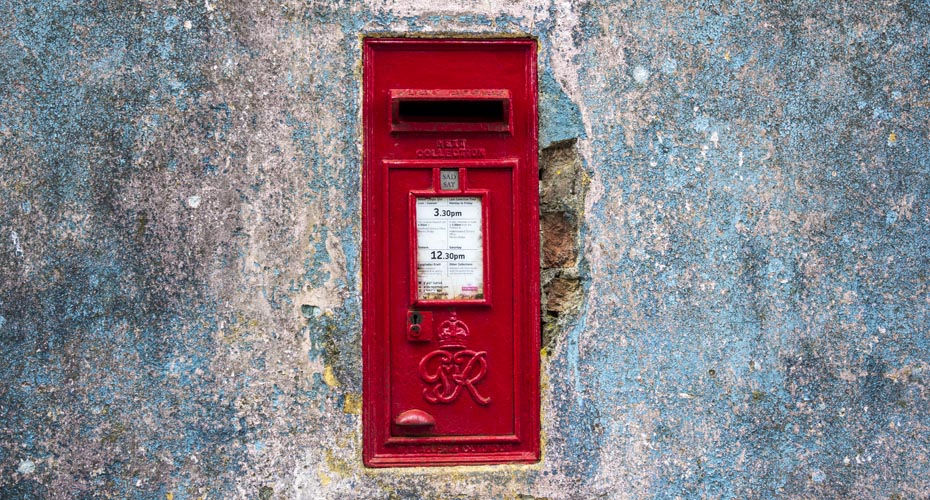 Red postbox in a wall