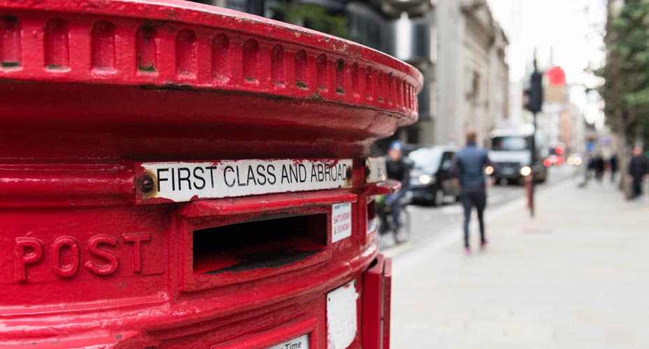 Close up of a street view with a red postbox