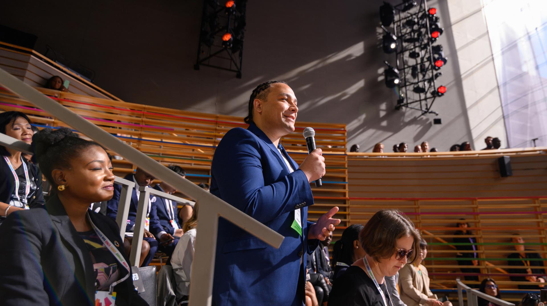 Man standing and speaking into microphone at a Goalkeepers event