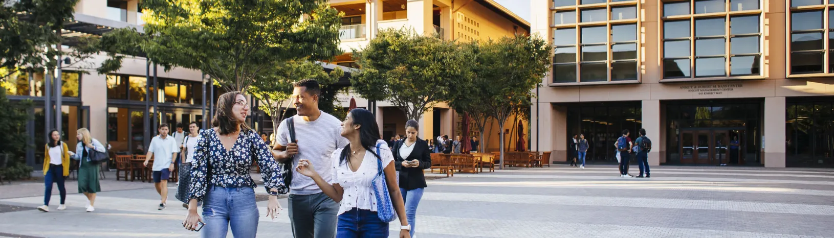 Three students walking together across Town Square