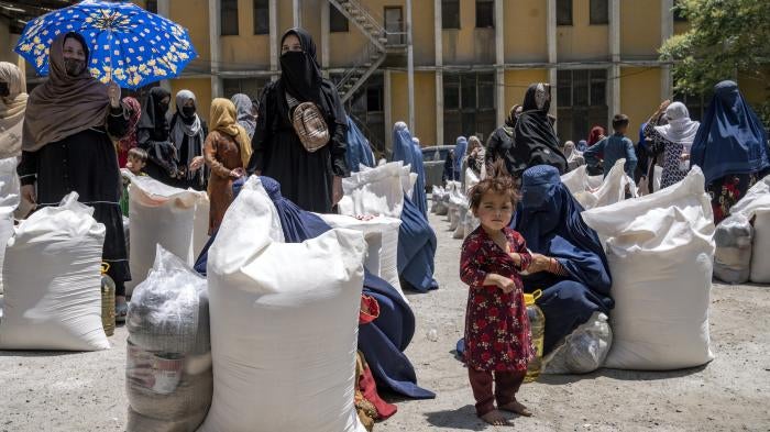 Afghan women receive food rations distributed by a humanitarian aid group, in Kabul, Afghanistan, May 28, 2023.