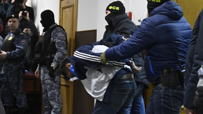 Federal Security Service officials bring Dalderjon Mirzoev, a suspect in the Crocus City Hall's massacre, to the Basmanny District Court in Moscow on March 24, 2024. 