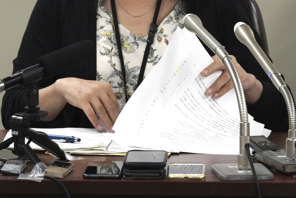 A plaintiff  speaks during a news conference at Tokyo District Court, Tokyo, Japan, July 11, 2023. 