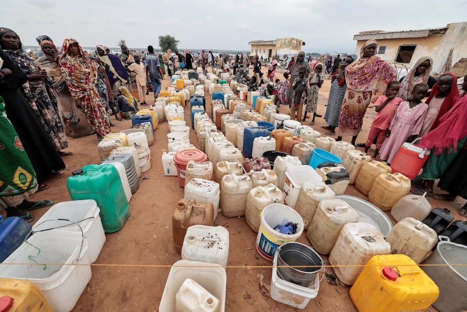 Sudanese women and children who fled the conflict in Geneina, in Sudan's Darfur region, line up at the water point in Adre, Chad, July 30, 2023. 