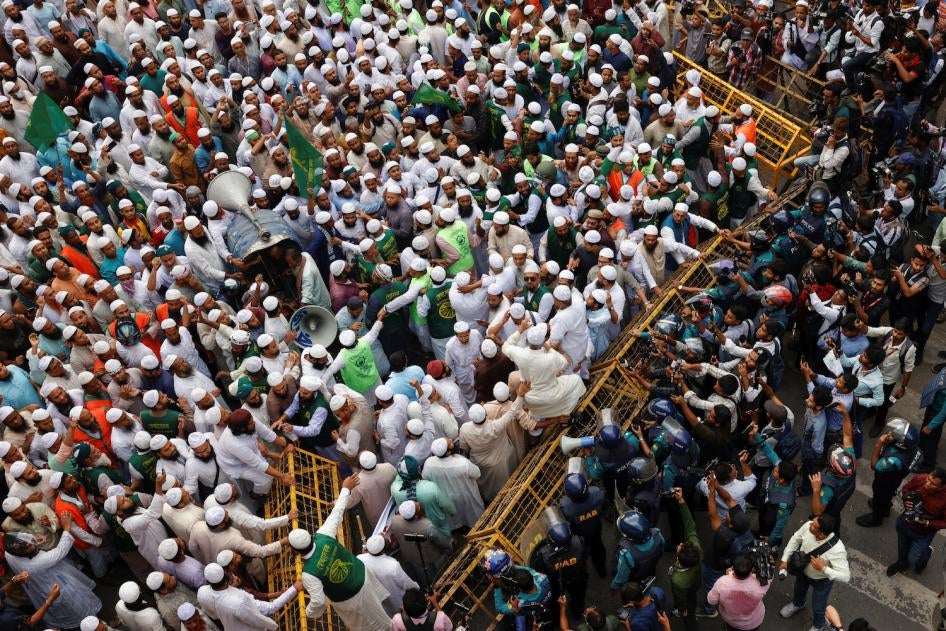 Members of an opposition political party in Bangladesh try to remove barricades as they join in a mass protest march demanding a free and fair election, in Dhaka, Bangladesh, November 15, 2023. 