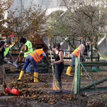 Italians and asylum seekers from the local specialized reception center work together to clear debris after floods in Belluno, Italy, November 2018. 