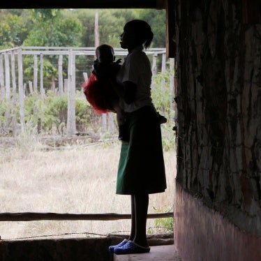 A 19-year-old woman carries her child outside her secondary school classroom in Nyeri, Kenya, January 8, 2021.