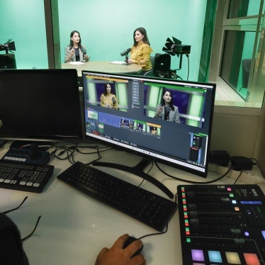 Women journalists being filmed in a tv news studio