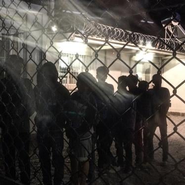 Unaccompanied children line up for an evening meal at a detention facility run by the Greek police.