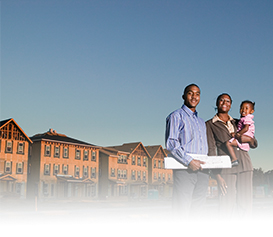 Housing: Family standing in front of houses