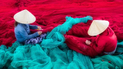 Two women sorting fishing nets in Viet Nam