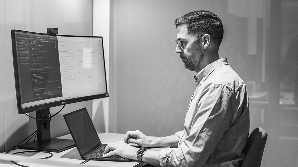 Young software developer in front of computer