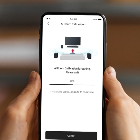 Person using LG Soundbar App on smartphone to connect to audio devices