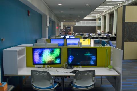 computer station with macs and large monitors