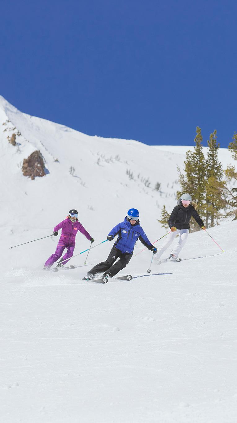 Two skiers getting a ski lesson