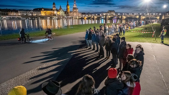 Mehrere tausend Menschen schließen für zehn Minuten eine Menschenkette rund um die Altstadt mit den Glockenschlägen der Dresdner Kirchen um 18 Uhr.