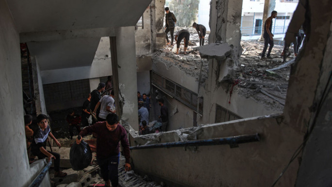 Palestinians check the damage inside a UN school-turned-shelter following an Israeli strike in the Al-Shati refugee camp on 7 November 2024