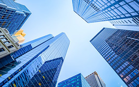 Looking skyward toward the tops of glass skyscrapers